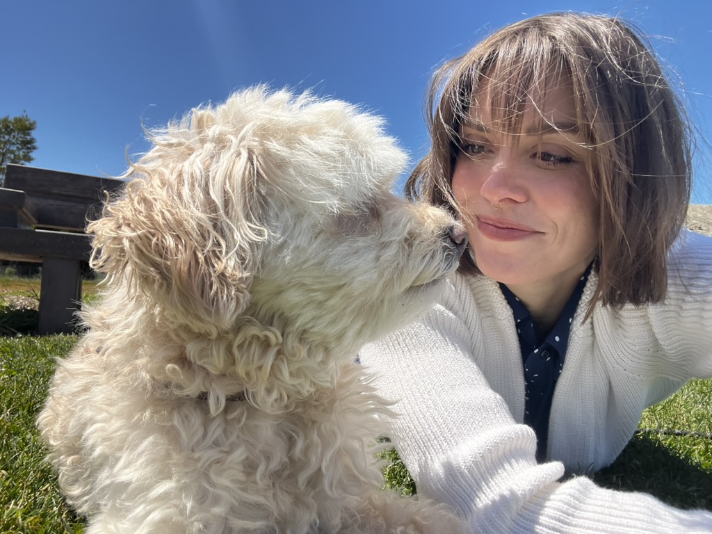 Bree nose to nose with Crickett, the curly-coated dog