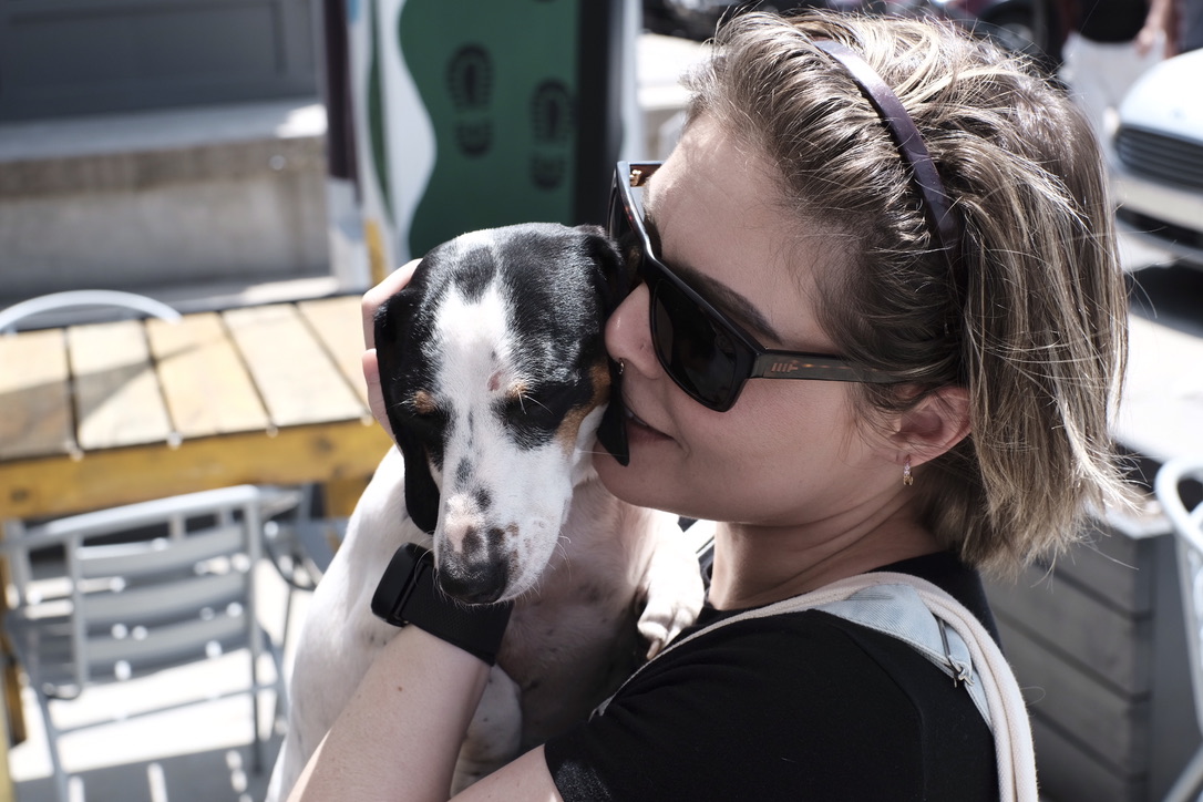 Bree cheek to cheek with a small dog in sunglasses